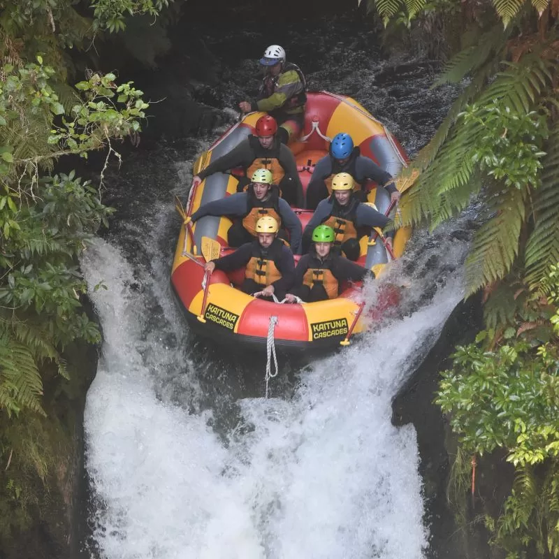 Outdoor education students rafting down a waterfall