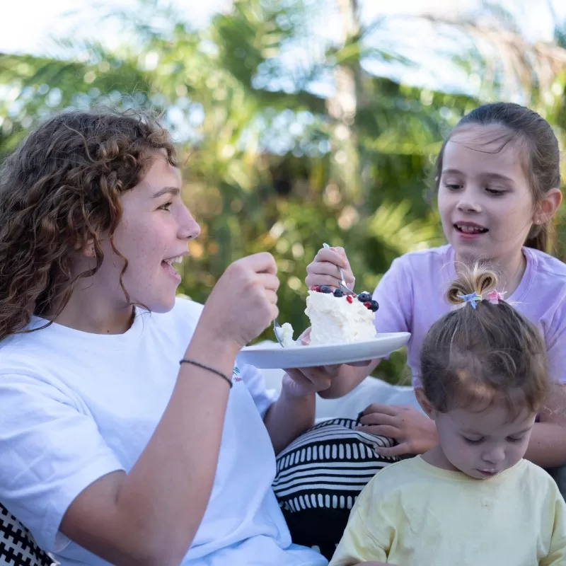 International student at Pakūranga College enjoying dessert with host family children