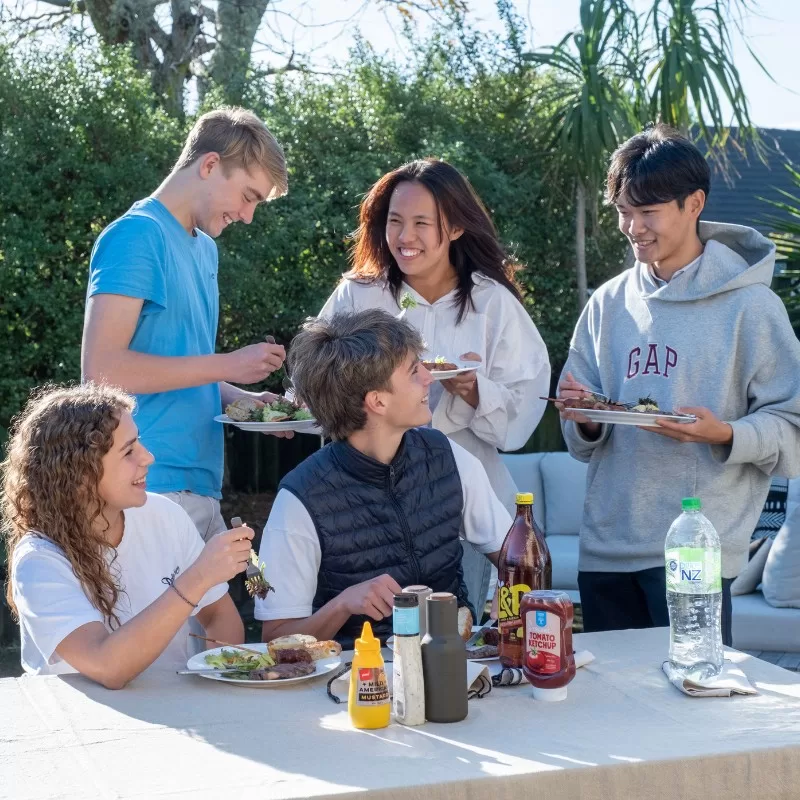 International students enjoying a meal at a homestay