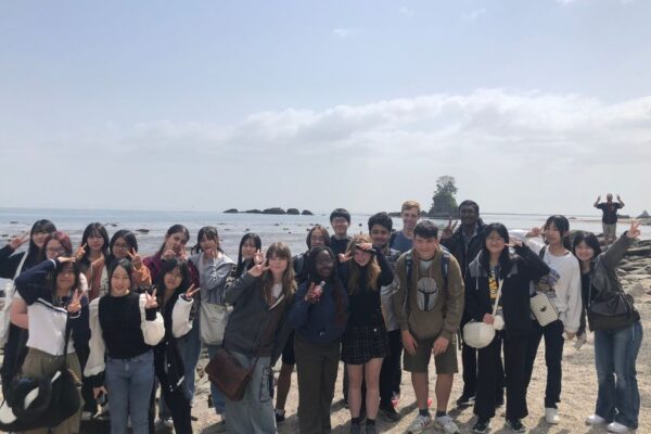 1 Students smiling for a photo at a Japan beach