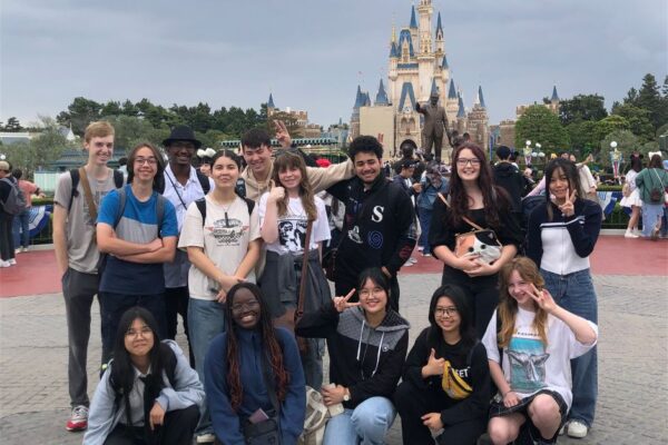 3 Students smiling at Japan Disneyland