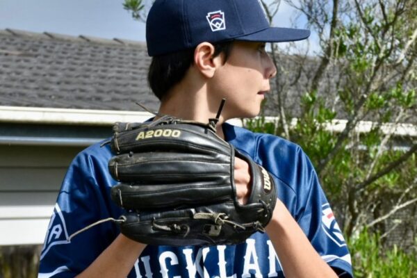 3 Pakūranga College student Simon Aukett in his Baseball kit, preparing to throw a ball