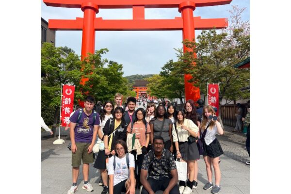 4 Students smiling at one of the Torii Gates in Japan