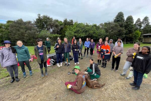1 Pakūranga College students posing before planting trees