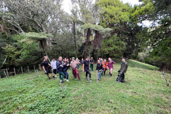 2 Pakūranga College students climbing up hill to plant trees