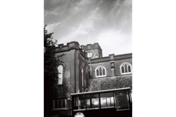 The back of the tower, showing the clock dials. The church bells are located just under it and were cast in the 1940s and 50s.
This photo required some walking around to get the right angle, as the sun would have caused lens flare. Kodak advised against taking photos pointed upward, but I see no problem with it. Note the 15-minute time difference on the clock since the first photo.